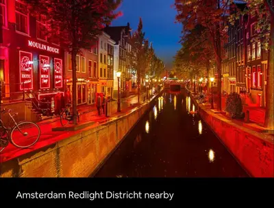 a canal in a city at night with red lights at Cozy family house with spacious garden in the nature near Amsterdam in Vijfhuizen