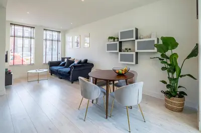 a living room with a table and chairs and a couch at Luxury City Home Alkmaar nearby Amsterdam. in Alkmaar