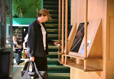 a man is looking at a display in a store at Poppies in Amsterdam