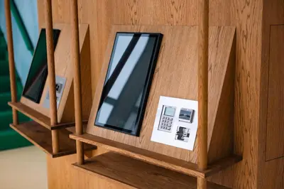 a wooden box with a cell phone in it at Poppies in Amsterdam