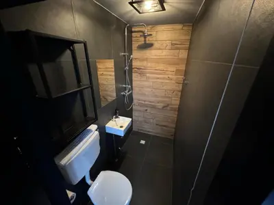 a small bathroom with a toilet and a sink at Modern guest house. in Bergen