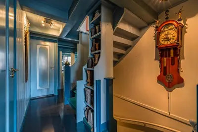 a hallway with a clock on the wall at De Ginkgo in het hart van Hoorn in Hoorn