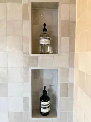 a bottle of wine in a niche in a bathroom at 30 steps to sand.. Light and spacious family villa in Zandvoort