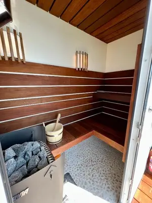 a room with wooden walls and a room with a box at Luxury Houseboat Liberdade with sauna and dinghy in Monnickendam