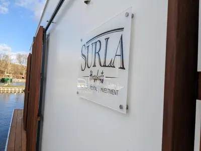 a sign on the side of a building at Luxury Houseboat Liberdade with sauna and dinghy in Monnickendam