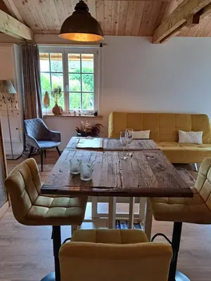 a dining room with a wooden table and chairs at Het Buitenleven in Spaarndam
