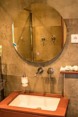 a bathroom with a sink and a large mirror at Bed & Breakfast Danina in Sassenheim