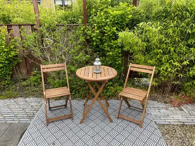 two chairs and a table with a tea kettle on it at Bed & Breakfast Danina in Sassenheim