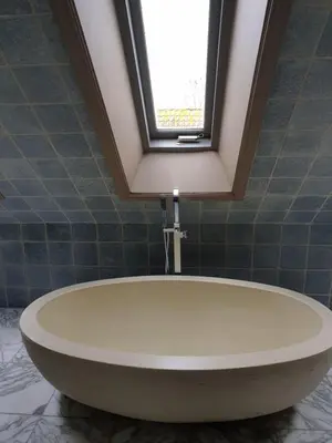 a bath tub in a bathroom with a window at Landlust in Purmerend
