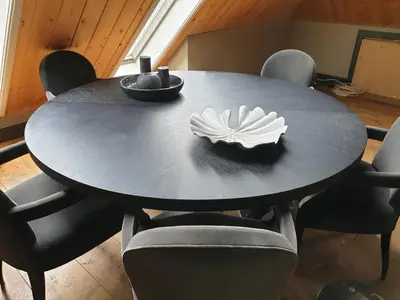 a black dining room table with a white flower on it at Landlust in Purmerend
