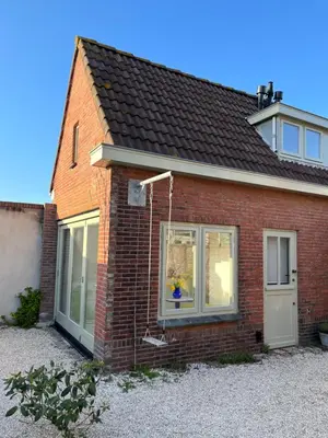 a red brick house with a white door and windows at Aventure, beach 500m, free parking in Noordwijk