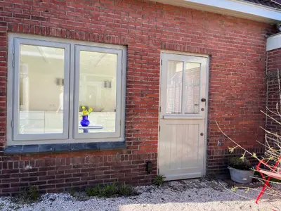 a brick house with a door and a window at Aventure, beach 500m, free parking in Noordwijk