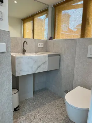 a bathroom with a sink and a toilet at Aventure, beach 500m, free parking in Noordwijk