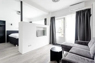 a living room with a couch and a bed at Kings Square in Zandvoort