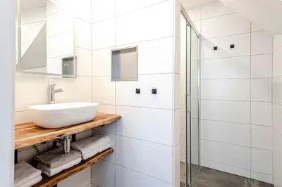 a bathroom with a sink and a shower at Kings Square in Zandvoort