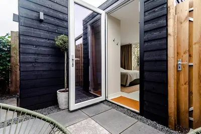 a sliding glass door leading to a bedroom at The Garden Suite in Zandvoort