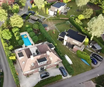 a aerial view of a house with a pool at Gastehuis Madiba met privé zwembad en jacuzzi in Zeewolde