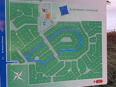 a sign with a map of a park at Gastehuis Madiba met privé zwembad en jacuzzi in Zeewolde