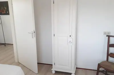 a pair of white closets in a room at Gastehuisie Goedemoed in Zeewolde