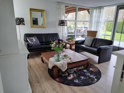 a living room with a couch and a coffee table at Gastehuisie Goedemoed in Zeewolde