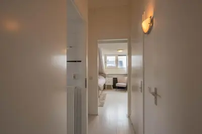 a hallway with a door leading to a bedroom at Meerzicht 99 - Luxury house 30 minutes from Amsterdam in Uitgeest