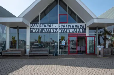 a building with a sign on the front of it at Meerzicht 99 - Luxury house 30 minutes from Amsterdam in Uitgeest