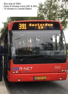 a red bus parked on the side of a street at B&B Sabai Sabai Amsterdam in Amsterdam