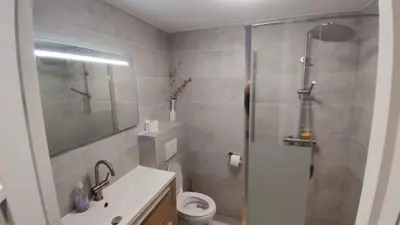 a bathroom with a shower and a toilet and a sink at B&B Sabai Sabai Amsterdam in Amsterdam