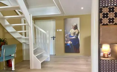 a hallway with a painting of a woman holding a baby at Smederij Abbekerk, guesthouse in Abbekerk