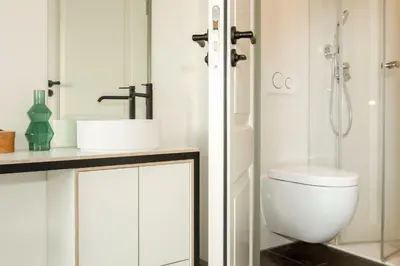 a bathroom with a toilet and a sink and a shower at The Red Ox - Super Central Canal View Rooms in Amsterdam