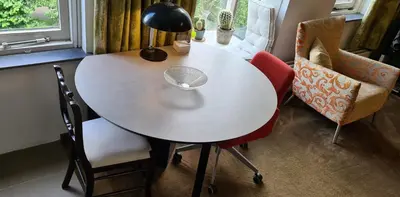 a white table with two chairs and a lamp at StudioRandijk in Nieuwegein