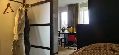 a bedroom with a bed and a desk in a room at StudioRandijk in Nieuwegein