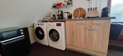 a kitchen with a washer and dryer in a kitchen at StudioRandijk in Nieuwegein