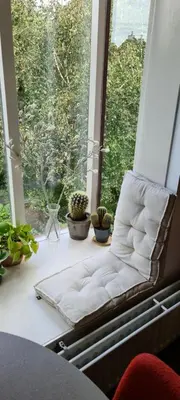 a white couch sitting on a window sill with plants at StudioRandijk in Nieuwegein