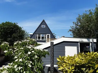 a grey garage with a black roof at BenB Humblebee met jaccuzi in Alkmaar