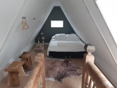 a bedroom with a bed in a attic at BenB Humblebee met jaccuzi in Alkmaar