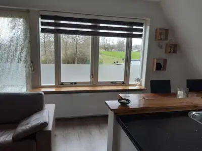 a living room with a window with blinds on it at BenB Humblebee met jaccuzi in Alkmaar