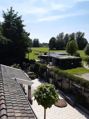 a view of a garden from the roof of a house at BenB Humblebee met jaccuzi in Alkmaar
