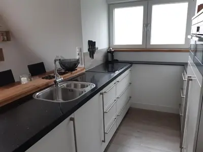 a kitchen with a sink and a window at BenB Humblebee met jaccuzi in Alkmaar