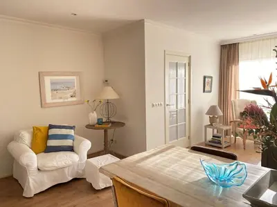 a living room with a couch and a table at Amstel BeachHouse Egmond aan Zee, 50m from the beach! in Egmond aan Zee