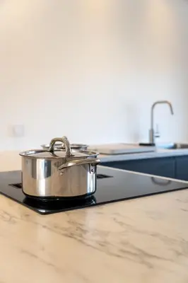 a pan sitting on top of a stove in a kitchen at Appartement aan Zee in Noordwijk aan Zee