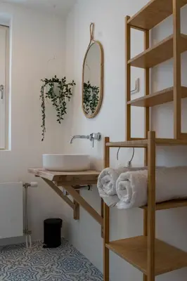 a bathroom with a sink and a mirror at Appartement aan Zee in Noordwijk aan Zee