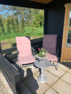 two chairs and a table on a porch at Fields 1216 in Zwaanshoek