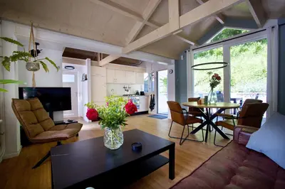 a living room with a vase of flowers on a table at Zandrijk in Egmond aan den Hoef
