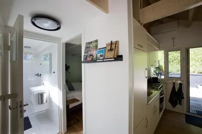 a small kitchen with a sink and a stove at Zandrijk in Egmond aan den Hoef